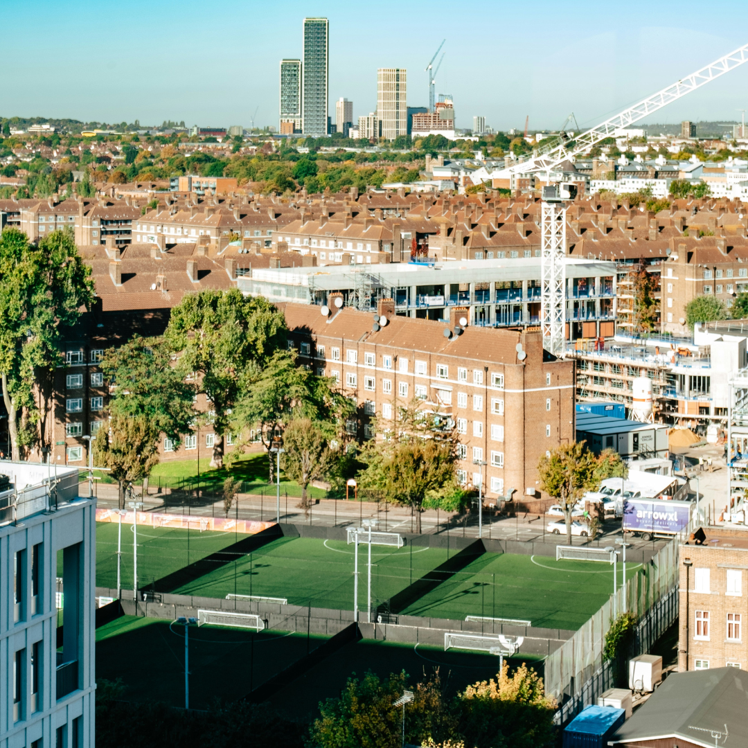 London city skyline looking down on inner city football pitch